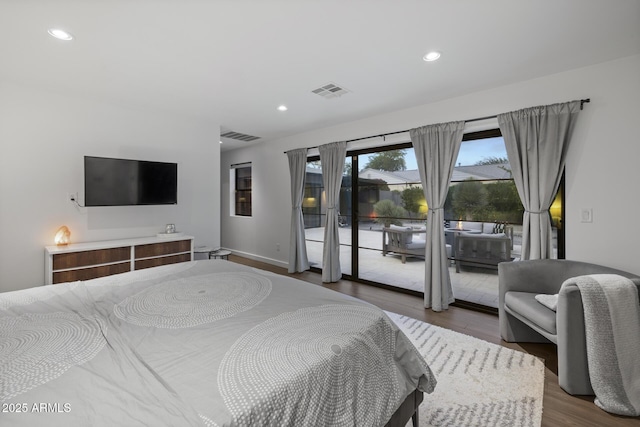 bedroom with access to exterior and hardwood / wood-style floors