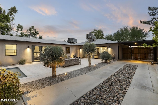 view of front of home with outdoor lounge area and central air condition unit