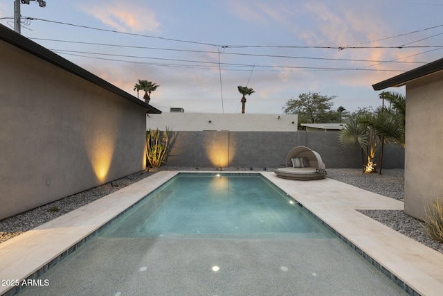 view of pool at dusk