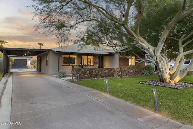 single story home with a carport and a yard