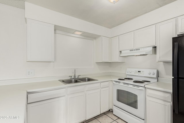 1512 W Crescent Ave, Mesa, AZ 85202 - kitchen featuring white range with electric cooktop, under cabinet range hood, a sink, freestanding refrigerator, and white cabinetry