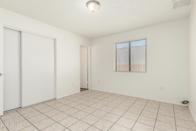 1512 W Crescent Ave, Mesa, AZ 85202 - unfurnished bedroom with a textured ceiling, a closet, and baseboards