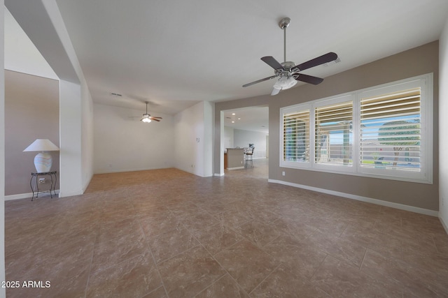 unfurnished living room with ceiling fan