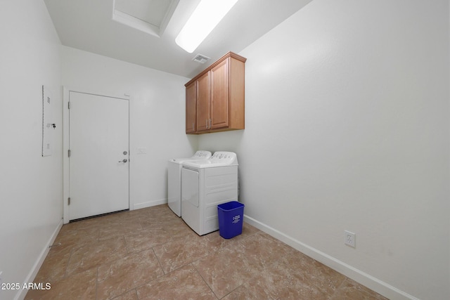 washroom featuring cabinets and washing machine and clothes dryer