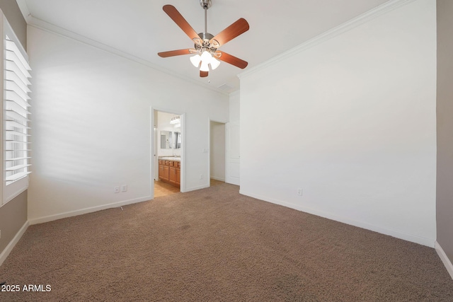 unfurnished bedroom featuring crown molding, ceiling fan, ensuite bathroom, and carpet flooring