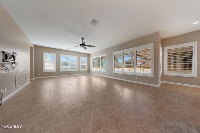 spare room featuring ceiling fan and light tile patterned floors