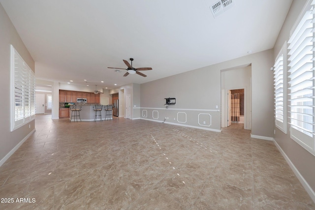 unfurnished living room featuring ceiling fan