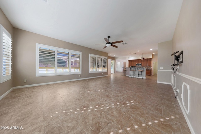 unfurnished living room with ceiling fan