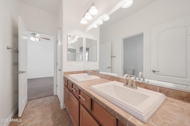 bathroom featuring vanity, ceiling fan, and toilet