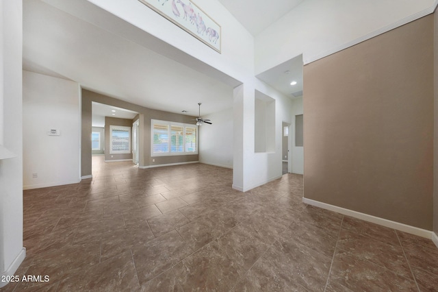 unfurnished living room featuring ceiling fan