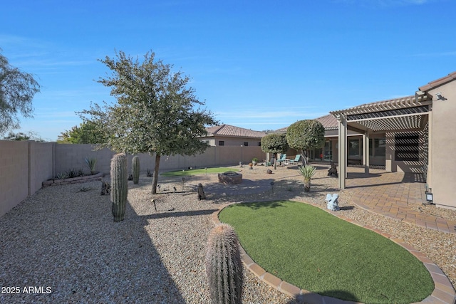 view of yard featuring a pergola, a patio area, and a fire pit