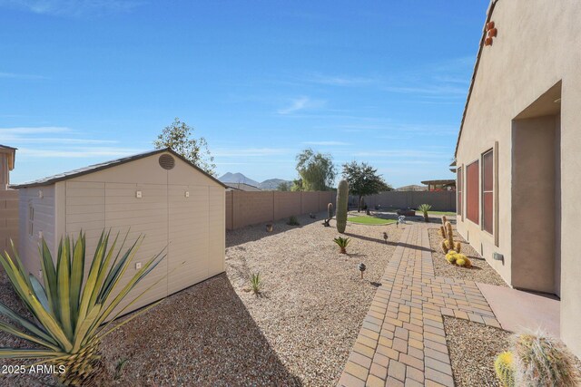 view of yard with a patio area and a storage shed