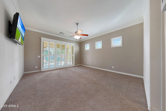 spare room featuring crown molding, carpet floors, and ceiling fan