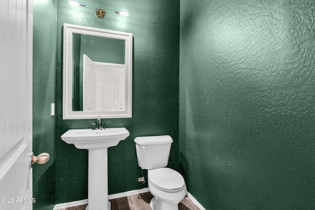 bathroom featuring sink, hardwood / wood-style flooring, and toilet