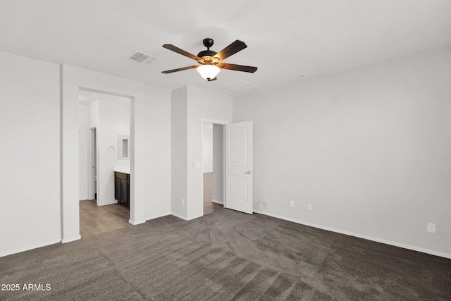 unfurnished bedroom featuring ceiling fan, connected bathroom, and carpet floors