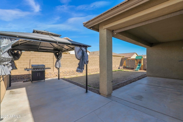 view of patio / terrace featuring a playground, a gazebo, and grilling area