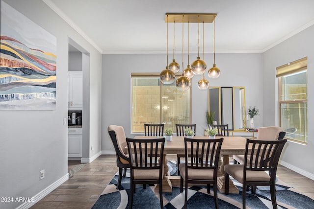 dining room with an inviting chandelier, crown molding, and dark wood-type flooring