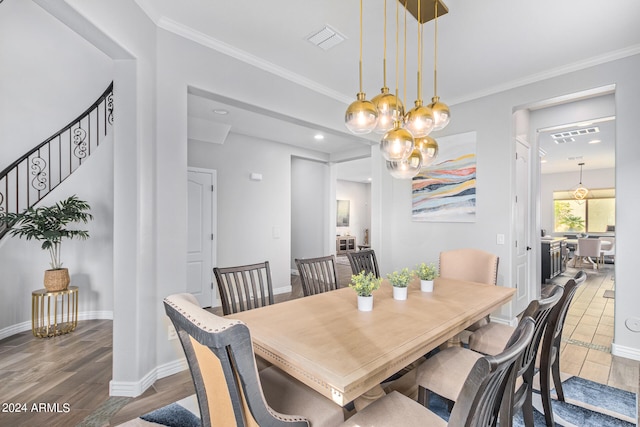 dining space featuring a notable chandelier, crown molding, and dark wood-type flooring