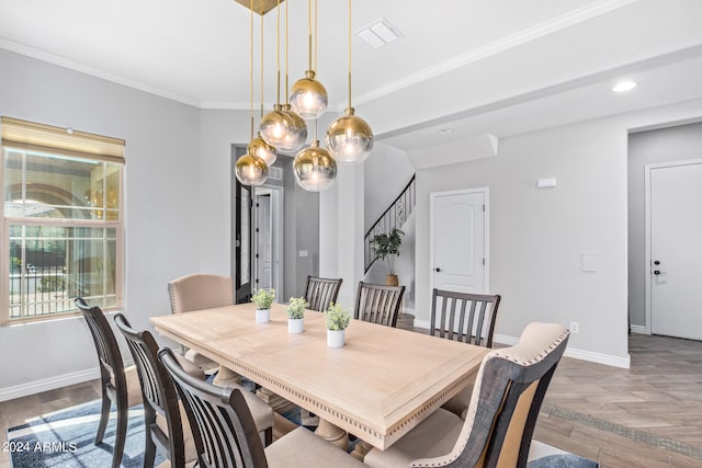 dining space with an inviting chandelier, light hardwood / wood-style flooring, and ornamental molding