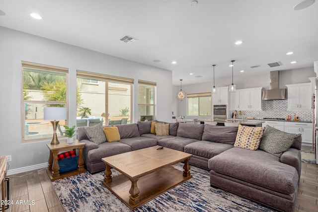 living room with light hardwood / wood-style flooring and sink