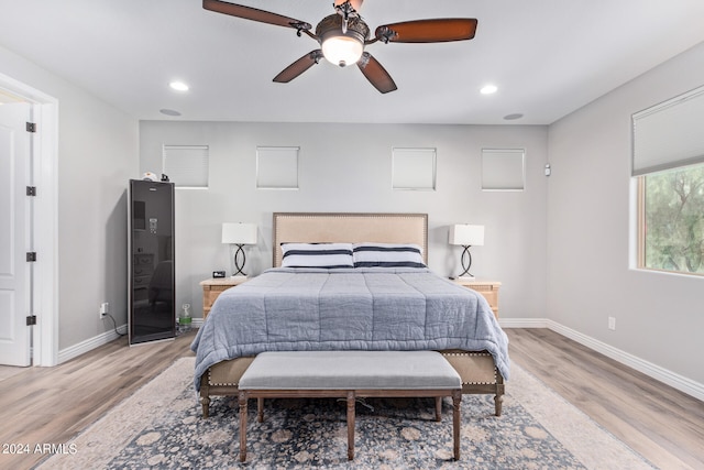 bedroom with light hardwood / wood-style floors and ceiling fan