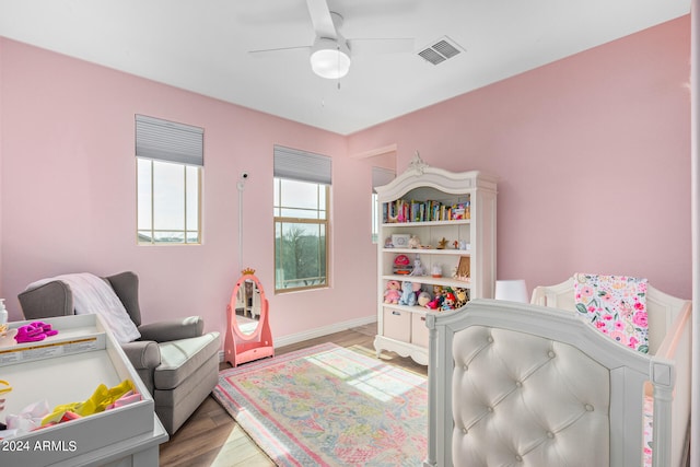 bedroom with ceiling fan and light wood-type flooring