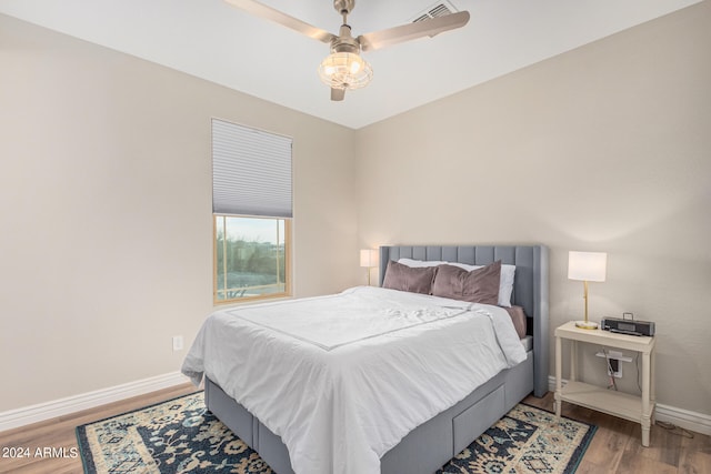 bedroom with wood-type flooring and ceiling fan