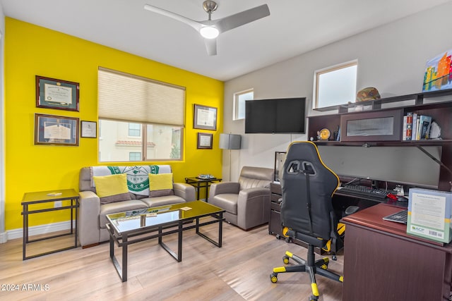 home office with ceiling fan and light hardwood / wood-style flooring