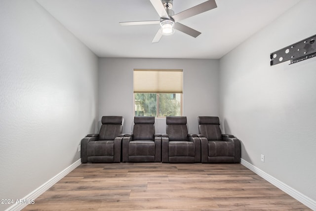 home theater featuring ceiling fan and light wood-type flooring