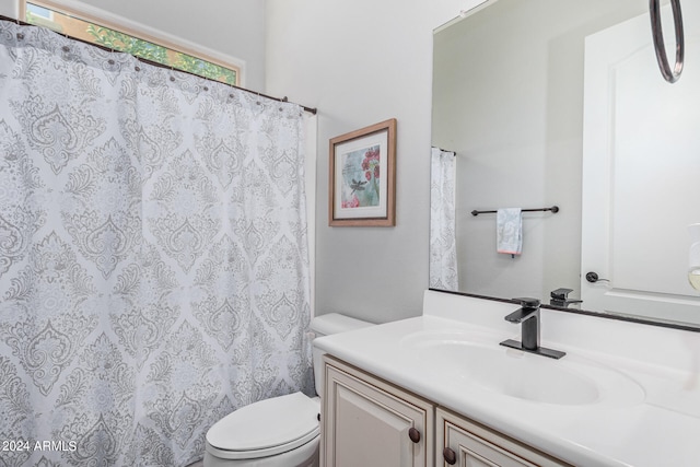 bathroom featuring toilet and vanity