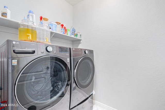 clothes washing area with washing machine and clothes dryer