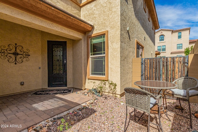 property entrance featuring a patio