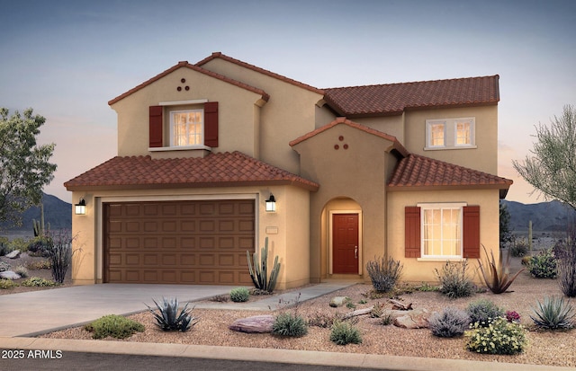 6354 W Rushmore Way, Florence, AZ 85132 - mediterranean / spanish home featuring a tile roof, concrete driveway, stucco siding, and an attached garage