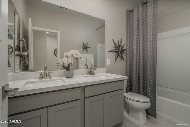 full bathroom with shower / bath combination with curtain, vanity, and toilet