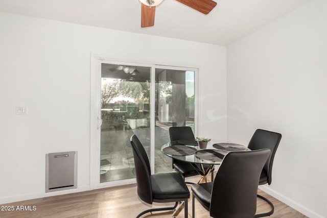 dining space with ceiling fan and light hardwood / wood-style floors