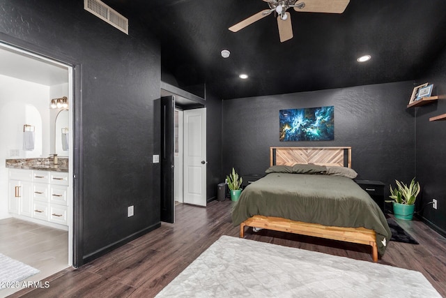 bedroom with dark wood-type flooring, connected bathroom, and ceiling fan