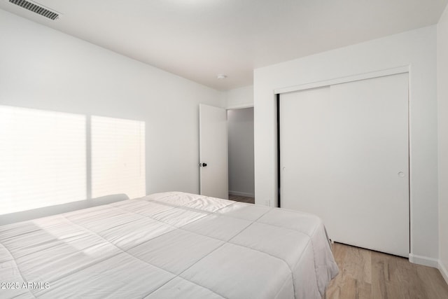 bedroom featuring a closet and light wood-type flooring