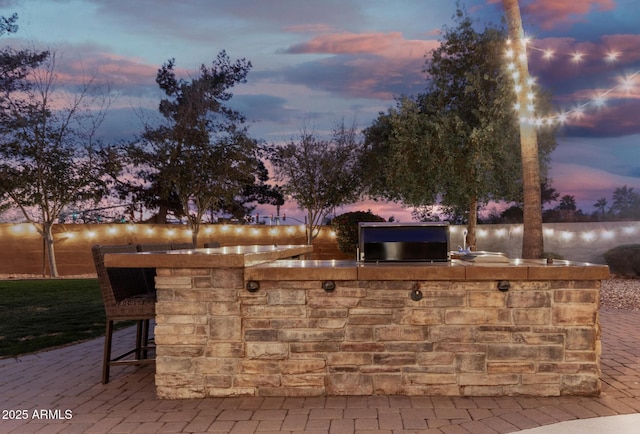 view of patio terrace at dusk