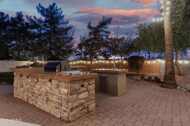 patio terrace at dusk with area for grilling