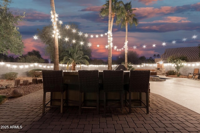 patio terrace at dusk with a bar