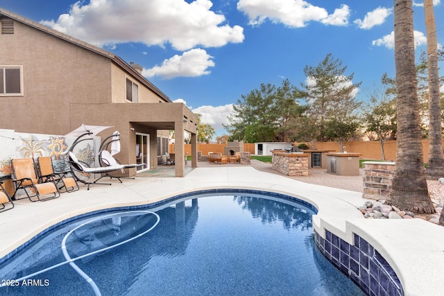 view of pool featuring area for grilling, a patio area, and an outdoor bar