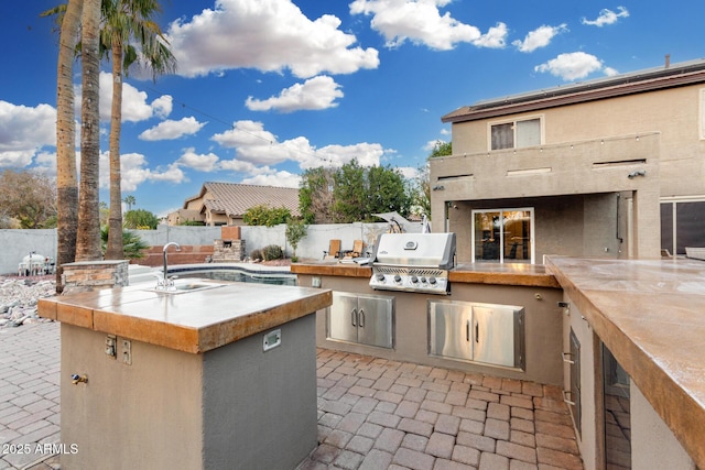 view of patio / terrace with area for grilling, sink, and grilling area