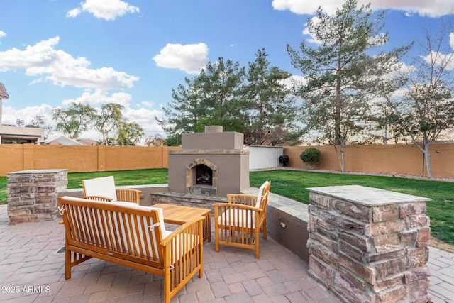 view of patio with an outdoor living space with a fireplace