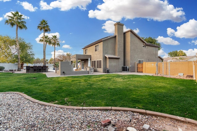 back of property featuring a patio, central AC, and a lawn