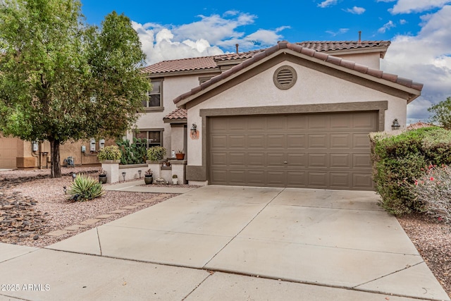 view of front of house featuring concrete driveway, an attached garage, a tile roof, and stucco siding