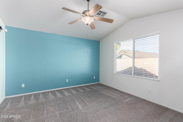 carpeted spare room with ceiling fan and lofted ceiling