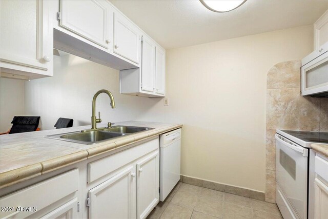 living area featuring ceiling fan, light tile patterned floors, and sink