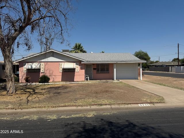 6231 N 25th Ave, Phoenix, AZ 85015 - ranch-style house featuring a garage, concrete driveway, and brick siding