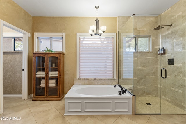 bathroom with plus walk in shower, tile patterned flooring, and a notable chandelier