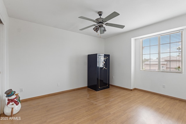 empty room featuring ceiling fan and light hardwood / wood-style flooring